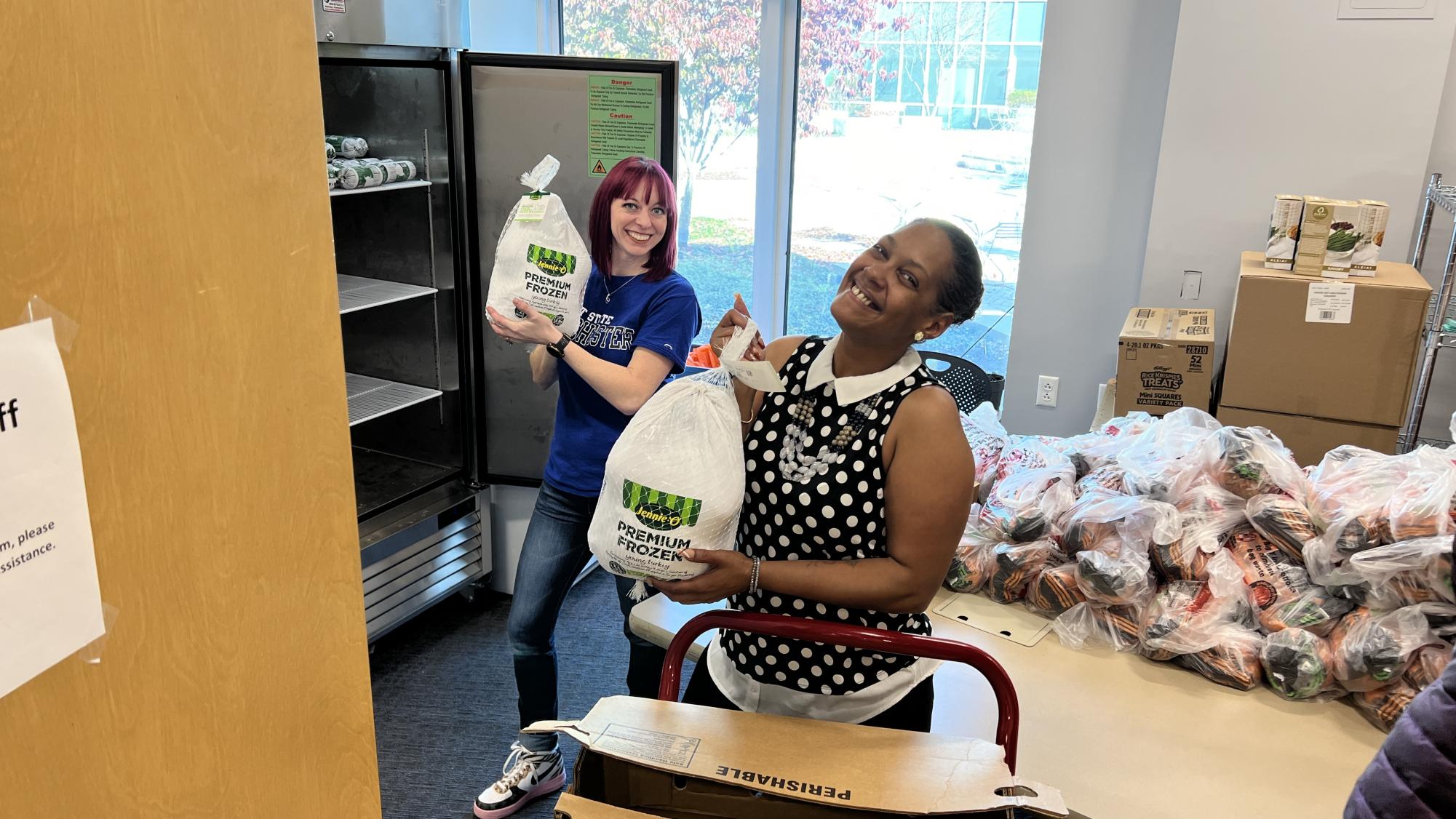 Laura Bruno, left, director of the Cougar Pantry, and Carole Lopez, president of the Student Government Association, prepare for a turkey giveaway before Thanksgiving.