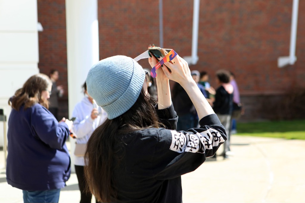 CT State Manchester student taking a picture of the solar eclipse.