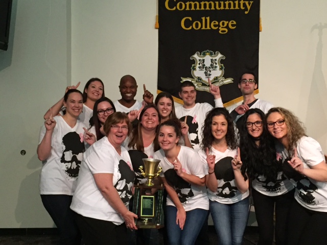 Susan Morison helps MCC Radiography Program students celebrate winning the first place trophy at the Connecticut Society of Radiologic Technologists (CSRT) Annual College Bowl in 2017.