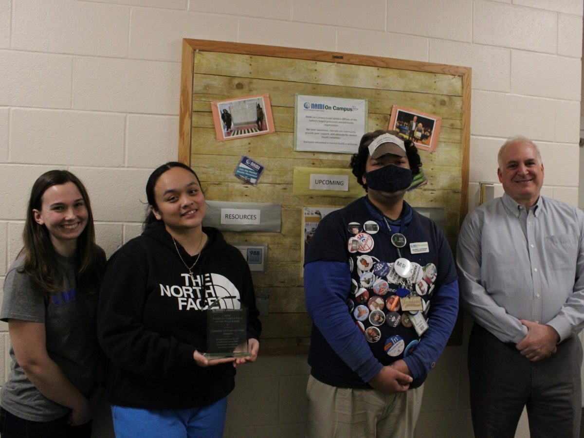 The NAMI club includes, from left, Co-Advisor Sage Hojda, Secretary Emily Malave, Vice President John Bogle and Co-Advisor Joe Navarra. Emily is holding the award the chapter won for its work.