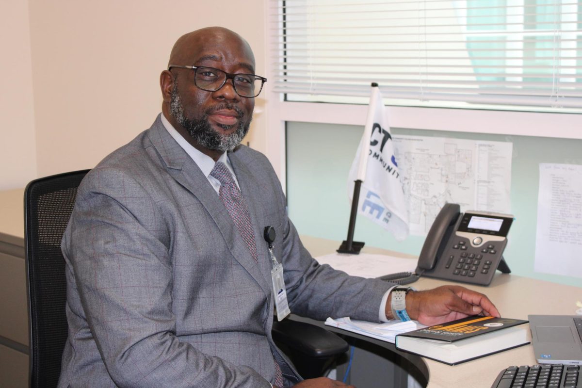 Dean Dr. Dwayne "Dalexh" Hunt settles into his campus office, SSC L285, as the new Dean of Students at CT State Manchester.