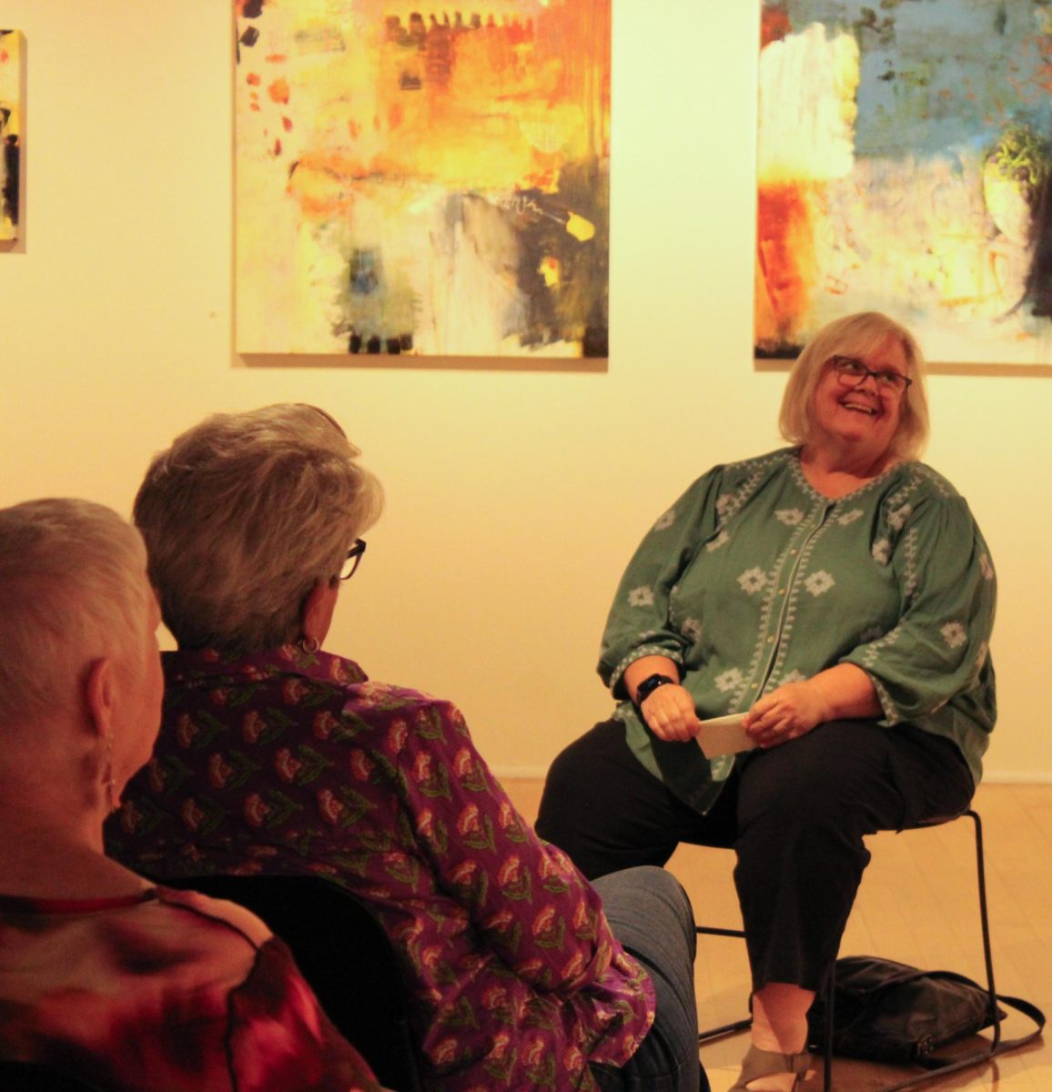 Artist Patricia Carrigan laughs with the crowd during a reception for her exhibit "FOGAREA" showing in the Hans Weiss Newspace Gallery through Oct. 6.