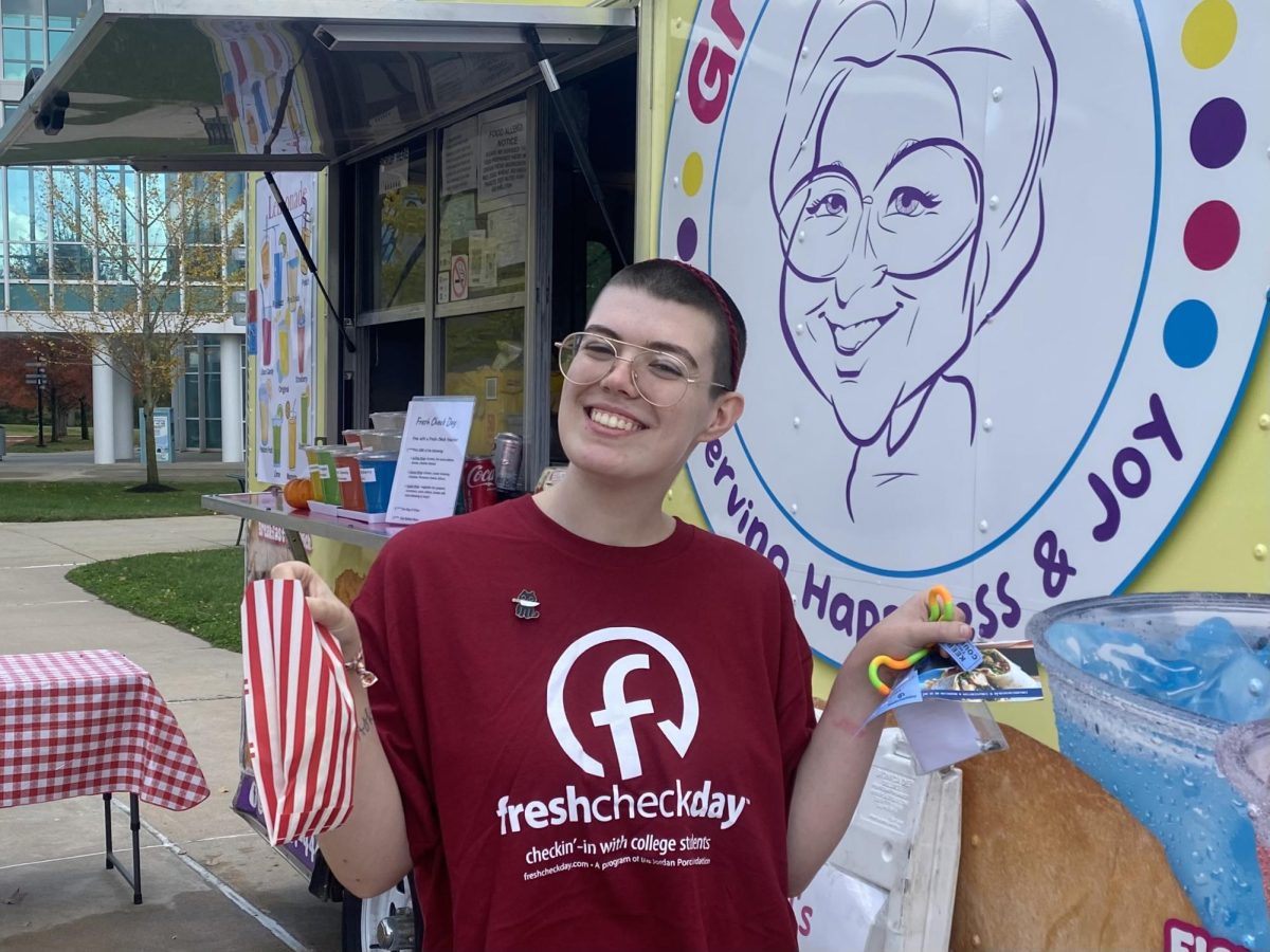 Esther Johnson, an Occupational Therapy Assistant major, prepares to collect a meal from Grandma Lil's food truck. Esther is one of many students that participated in the Fresh Check Day stamp program. Students collected stamps by visiting various tables and then were able to get a ticket for a meal.