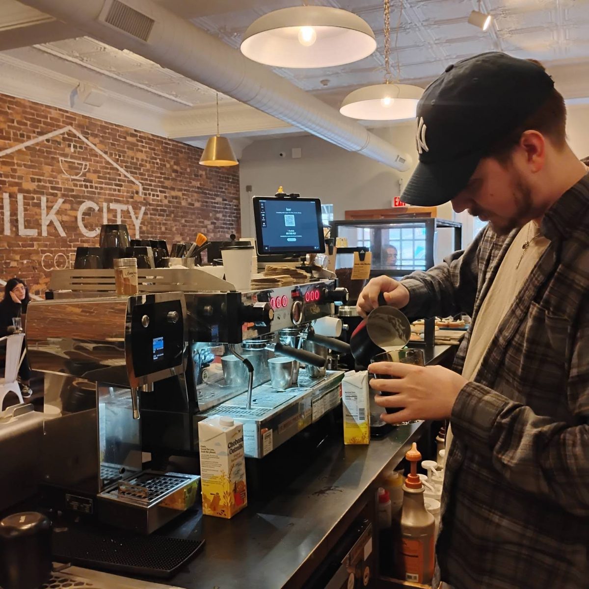 Jeremy Gerhard, lead staff member and barista at the Manchester location, puts the finishing touch on an order of Silk City Coffee’s new Vanilla Bean Lavender Coffee. 