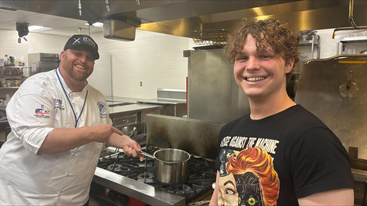 Chef Nicholaus Rajski, left, and student Logan Wolf stirred the bowling hot sap in the culinary kitchen until it turned to syrup.
